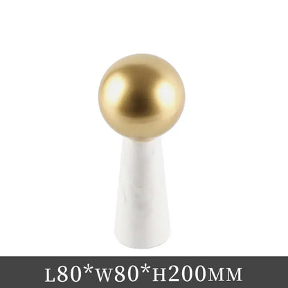 Modern golden ball marble cone ornament featuring a gold spherical knob on a white marble base for living room decor