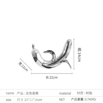 A sleek metallic gold banana figurine made of resin modern golden banana sculpture for living room decor