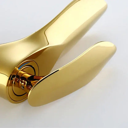 Modern golden bathroom faucet with a sleek curved single handle and polished metallic finish for decorbites golden bathroom decor