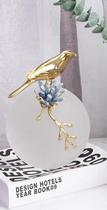 Decorbites golden bird brass sculpture in gold perched on frosted glass base with blue crystal branches for living room decor