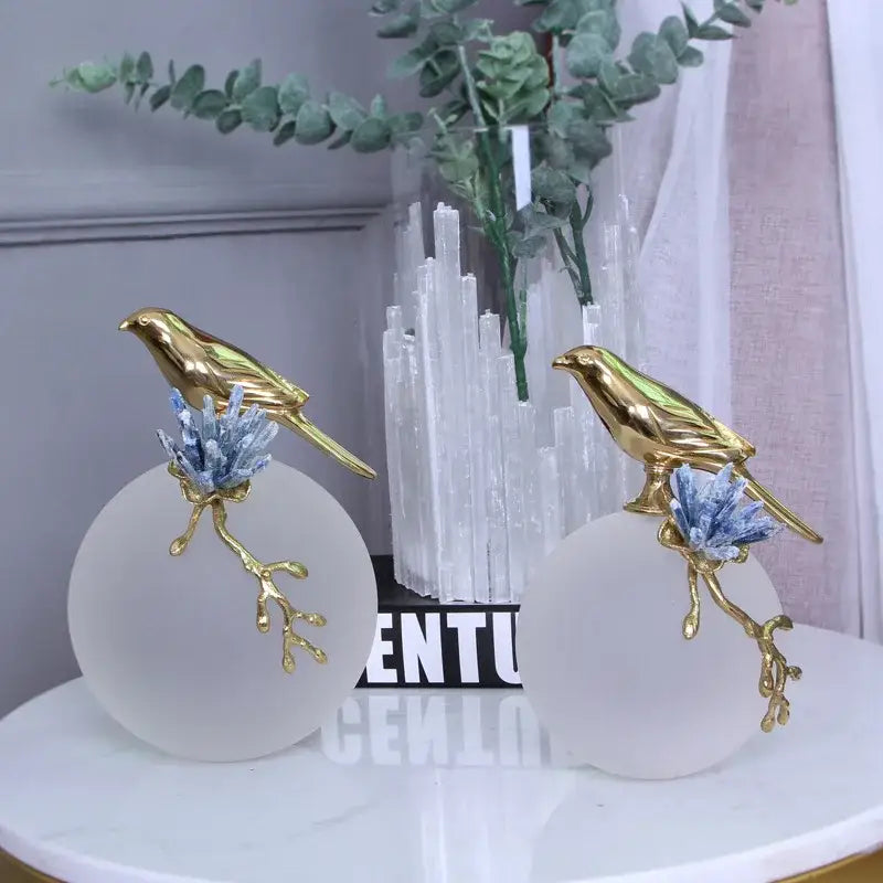 Modern golden bird brass sculpture decorbites featuring frosted white bases with blue crystal accents for living room decor
