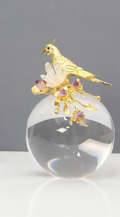 Modern golden bird brass sculpture featuring a golden parrot on a crystal sphere with amethyst and quartz decorbites golden bird