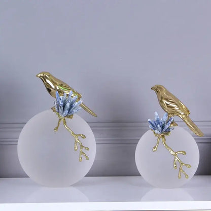 Modern golden bird brass sculpture with blue crystal branches atop frosted white bases for living room decorbites decor