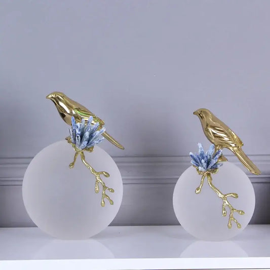 Modern golden bird brass sculpture with blue crystal branches atop frosted white bases for living room decorbites decor