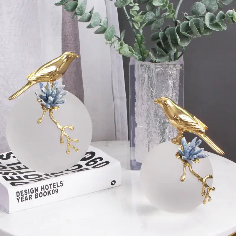 Modern golden bird brass sculpture decorbites featuring golden bird figurines on frosted glass with blue crystal branches