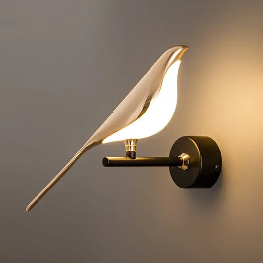 A sleek gold-toned decorbites golden bird led wall lamp with smooth metallic finish and illuminated rotatable body