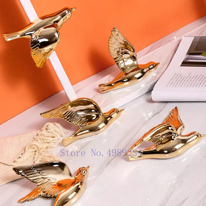 Modern golden bird wall hanging featuring reflective ceramic figurines with detailed wings for living room decor