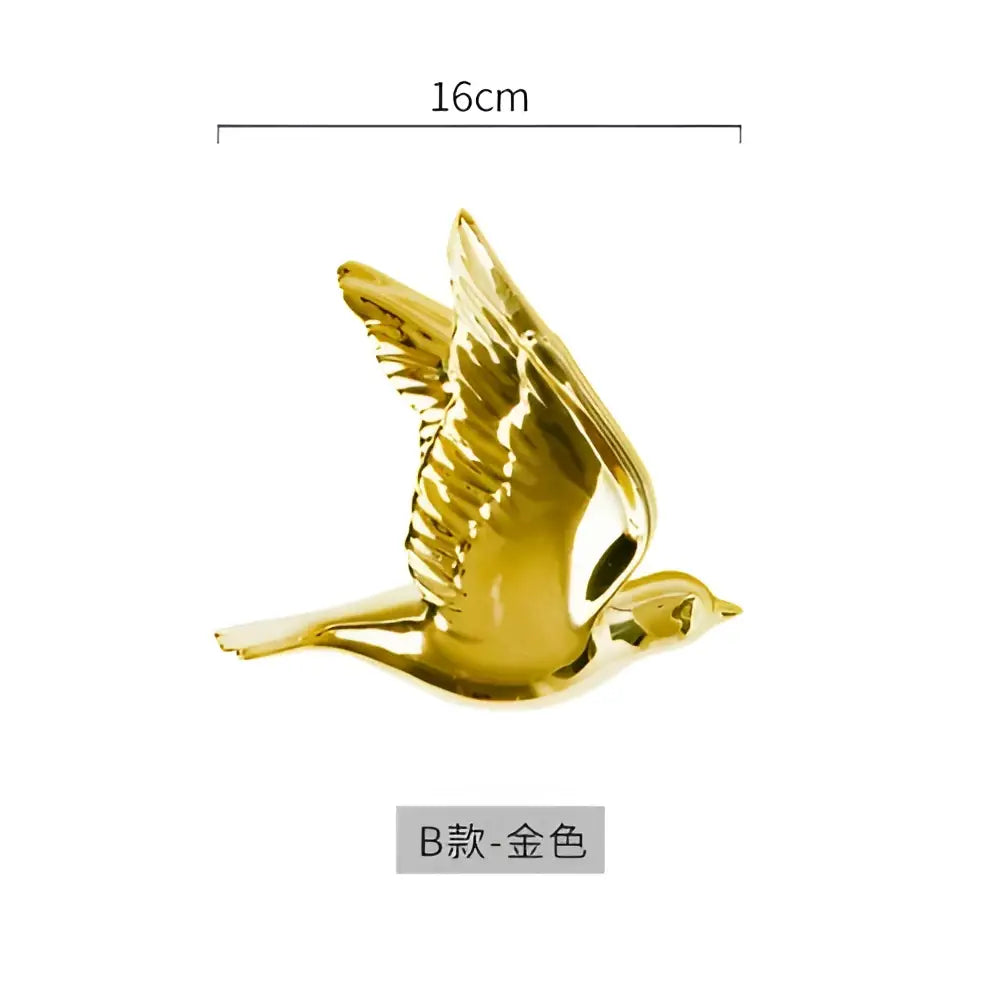 Modern golden bird wall hanging with detailed wings and sleek polished finish for living room decor