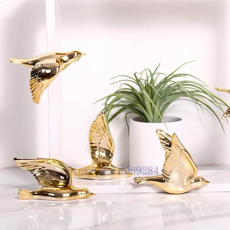 Modern golden bird wall hanging with reflective metallic finish and detailed feathers for living room decor