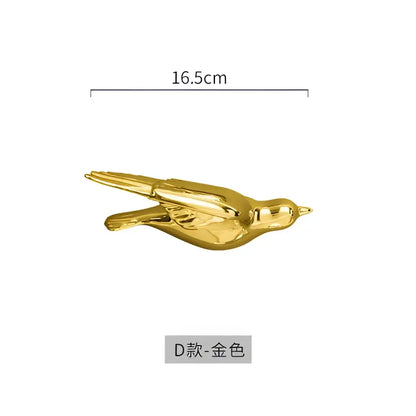 Modern golden bird wall hanging featuring a 16.5cm sleek metallic bird wall hanging with detailed wings and tail design