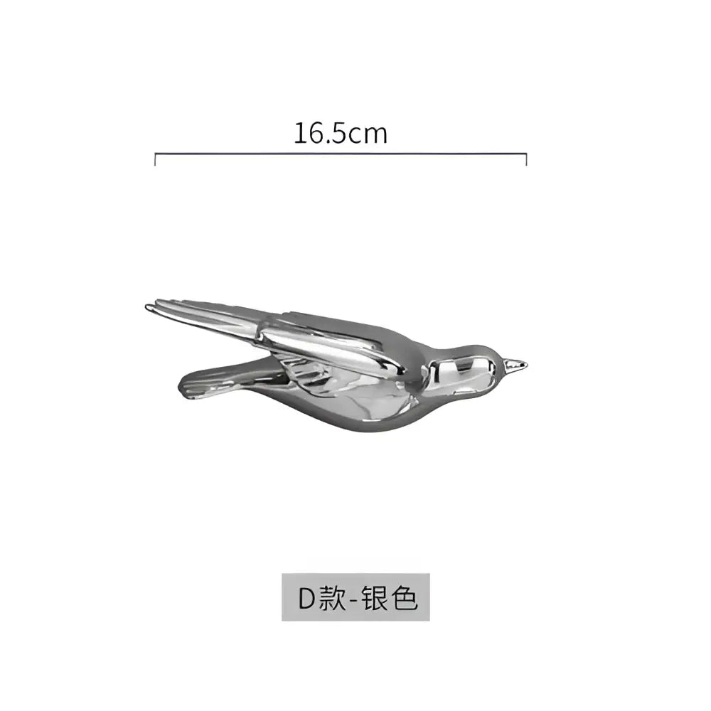 Silver metallic bird figurine with sleek reflective surface and detailed wings for modern golden bird wall hanging decor