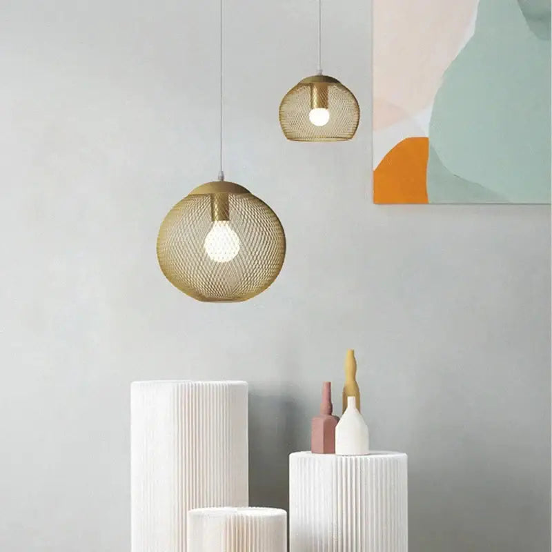 Modern golden birdcage led pendant light with gold mesh spherical design and visible bulb interiors for kitchens