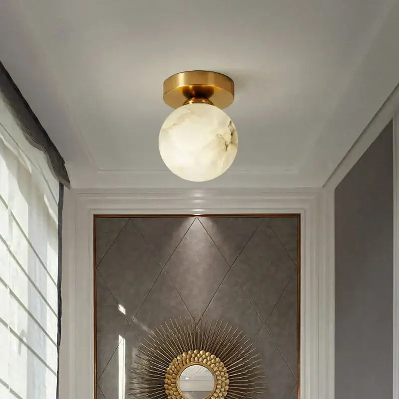 Modern golden brass ceiling lamp with gold finish and white marble-like glass globe for bedroom decorbites golden brass