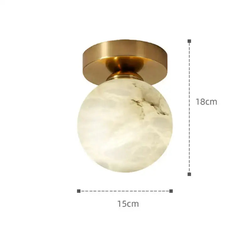 Modern golden brass marble ceiling lamp with off-white round globe and brushed brass mounting base by decorbites golden brass