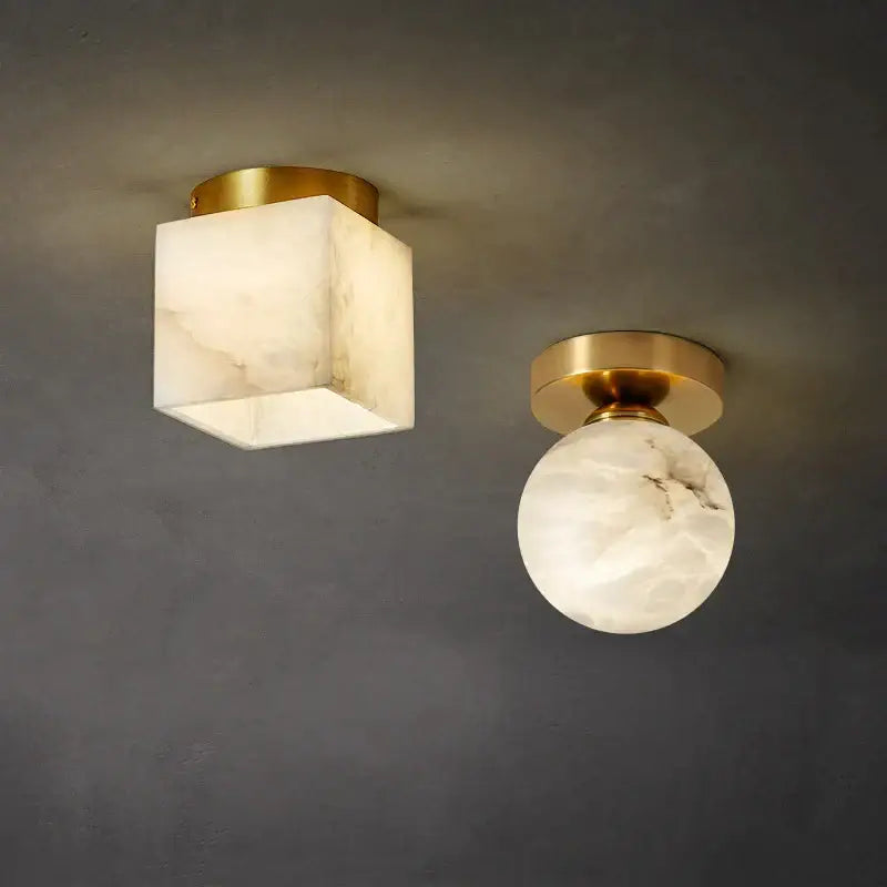 Two modern ceiling lamps with square and round white marble shades on golden brass decorbites fixtures for bedroom decor