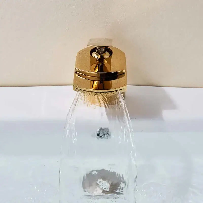 Modern golden brass waterfall vessel sink faucet with polished gold-toned brass waterfall and angular design decorbites golden brass
