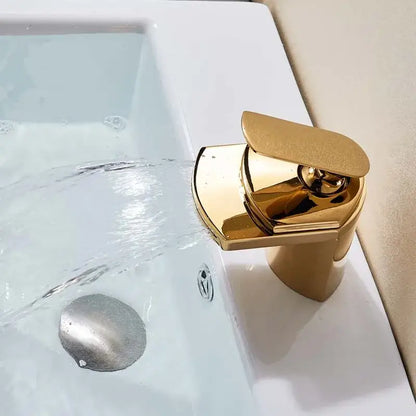 Modern golden brass waterfall vessel sink faucet with a sleek, minimalist design and polished brass waterfall finish