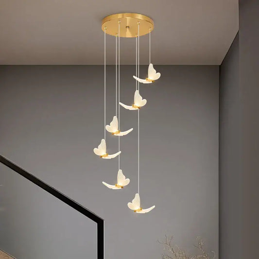 Modern golden butterfly led chandelier with five illuminated white butterfly pendants in gold decorbites golden butterfly style