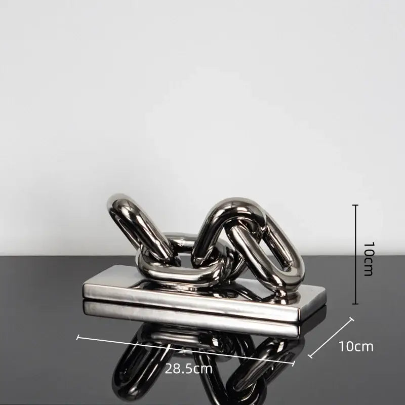 Shiny metallic golden chain home decoration figurine sculpture with interlocking links on a rectangular base