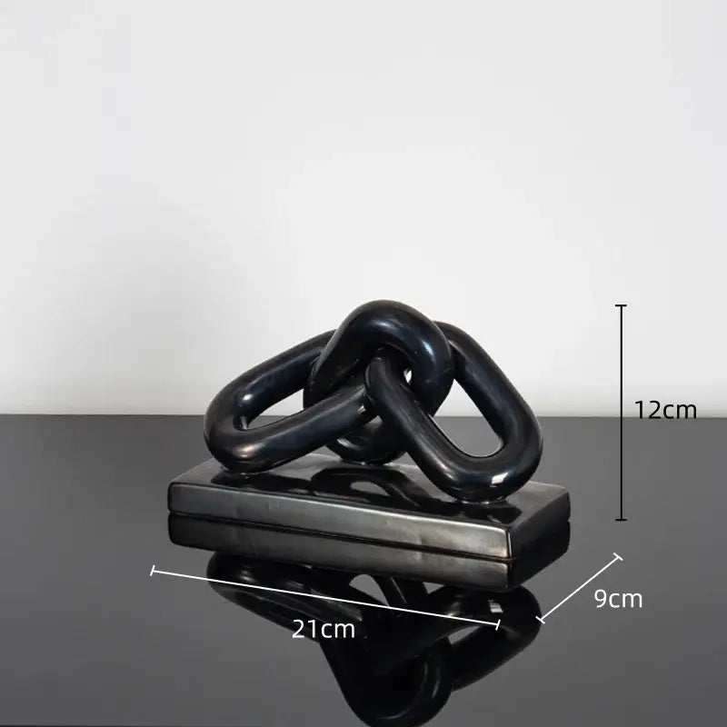 Black glossy ceramic chain sculpture on rectangular base as modern golden chain home decoration figurine for living room