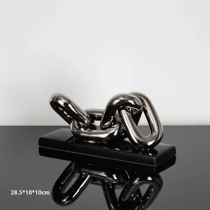 Modern golden chain home decoration figurine with shiny metallic chain sculpture on sleek black rectangular base