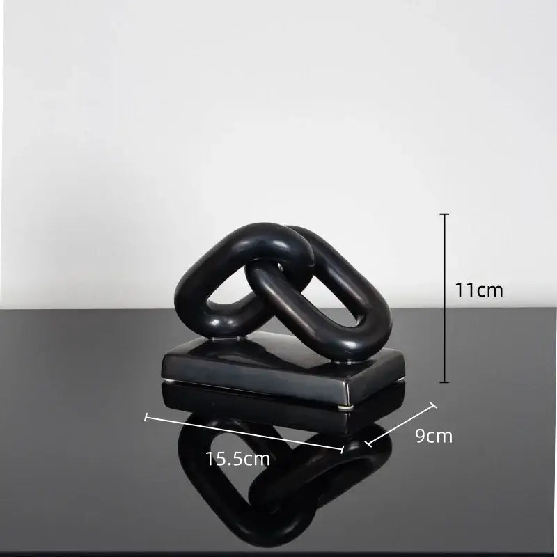 Black glossy ceramic home decoration figurine featuring two interlocking chain links on a square base for modern decor