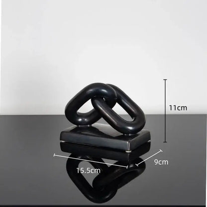 Black glossy ceramic home decoration figurine featuring two interlocking chain links on a square base for modern decor