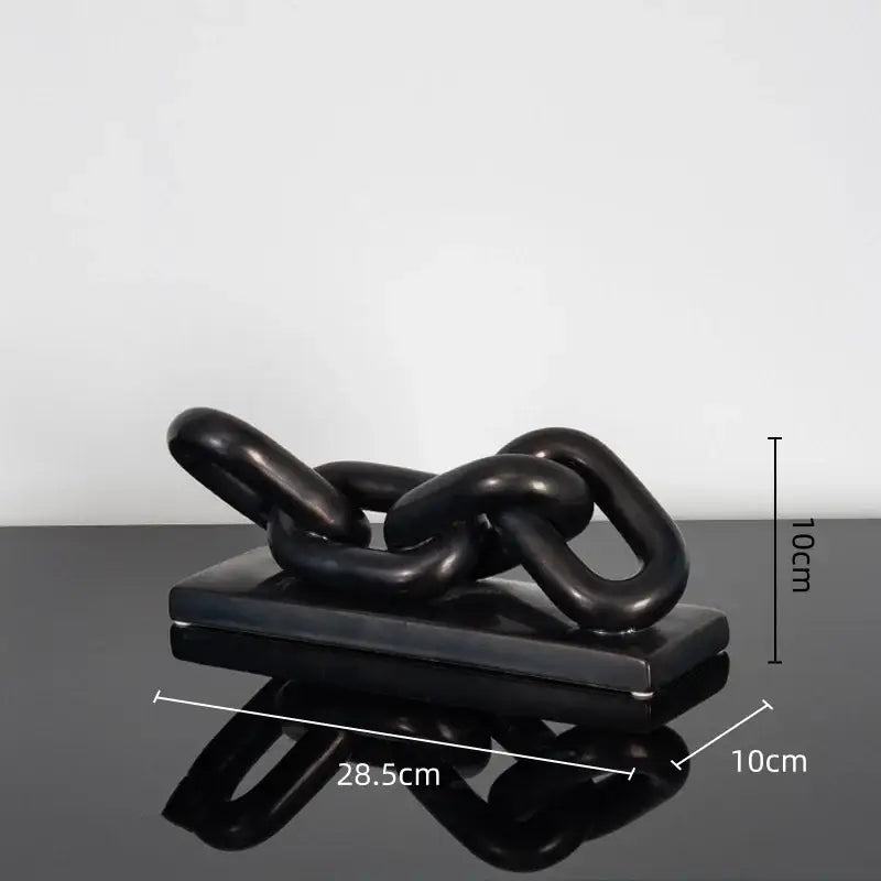 Modern golden chain home decoration figurine featuring a black glossy chain sculpture on a matching rectangular base