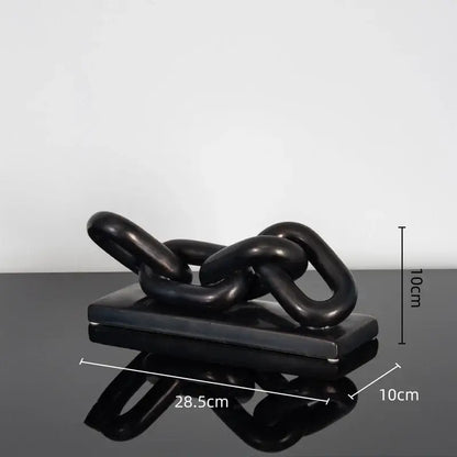 Modern golden chain home decoration figurine featuring a black glossy chain sculpture on a matching rectangular base
