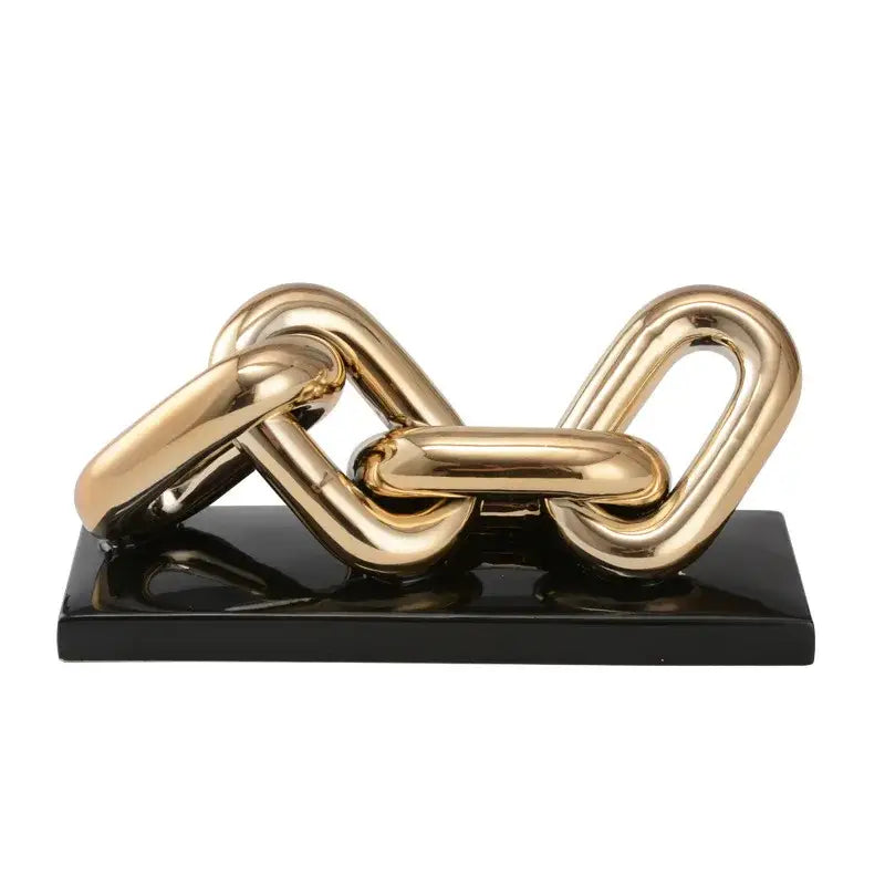 Modern golden chain home decoration figurine featuring a gold-toned metallic sculpture on a glossy black base