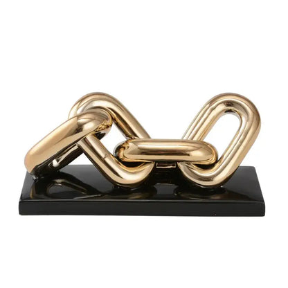 Modern golden chain home decoration figurine featuring a gold-toned metallic sculpture on a glossy black base