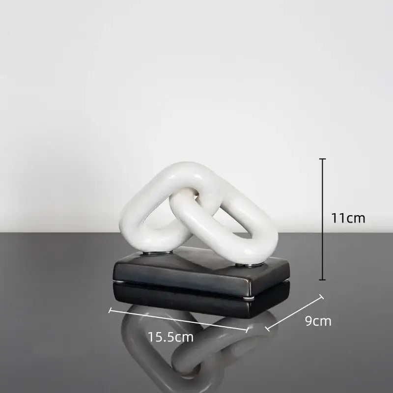 White ceramic chain home decoration figurine on black base resembling modern golden chain living room sculpture