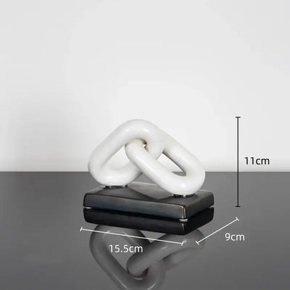 White ceramic chain home decoration figurine on black base resembling modern golden chain living room sculpture