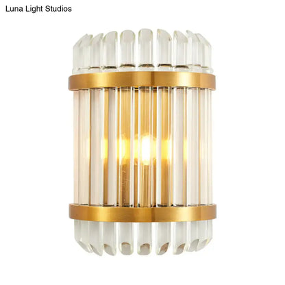 Modern golden crystal shade wall sconce featuring gold-toned metal, clear glass rods, and fluted crystal accents for bedroom lighting