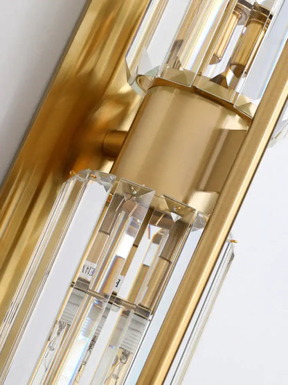 Modern golden decorbites crystal wall light with gold-toned chandelier and clear prisms for elegant bedroom decor