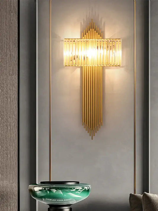 Modern golden decorbites crystal wall light with vertical glass rods and warm glowing light for bedroom decor