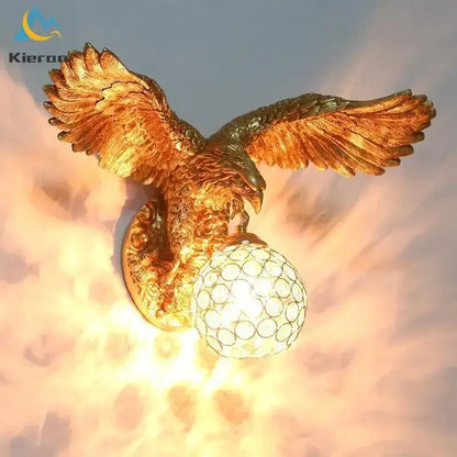 Modern golden eagle crystal led wall lamp with detailed feather texture and crystal globe base for bedroom living room