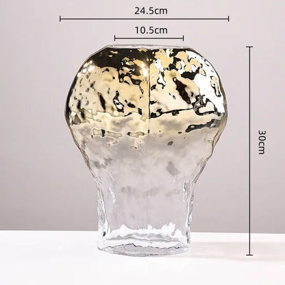 A tall modern golden geometric glass vase with a metallic gold and black marbled top and clear bottom for decorbites decor