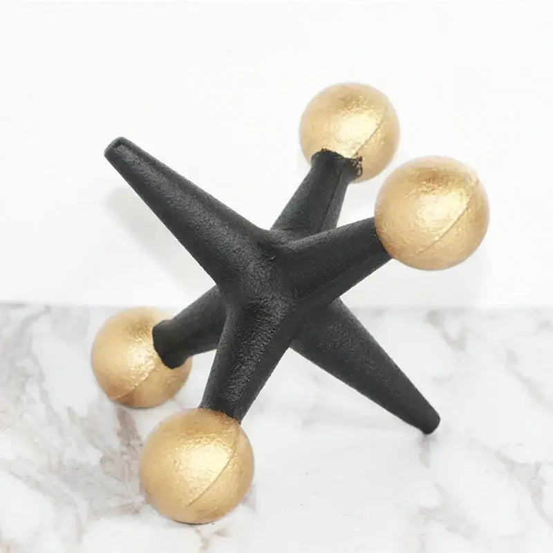 Modern golden geometric resin molecular model decor featuring black and gold metallic star with spherical golden tips
