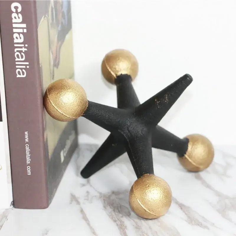 Black and gold star-shaped bookend with matte finish made of golden geometric resin molecular model for modern decorbites decor