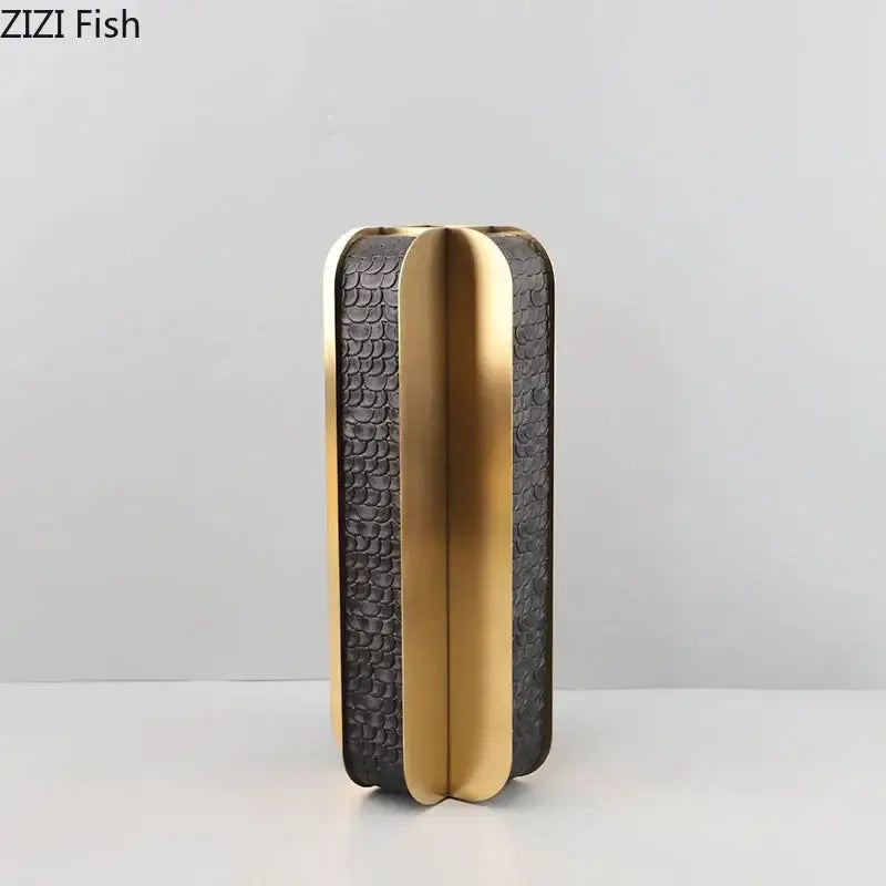 Black textured clutch with gold trim and sleek modern design complementing decorbites golden geometry vase decor