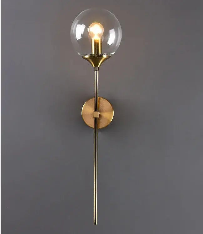 Modern golden glass ball wall lamp with brass finish and clear smoked glass globe featuring exposed bulb decorbites golden glass