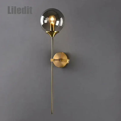 Modern golden glass ball wall sconce with a gold-toned metallic stem and spherical smoked glass for living room decorbites golden glass lighting