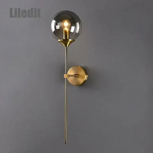 Modern golden glass ball wall sconce with a gold-toned metallic stem and spherical smoked glass for living room decorbites golden glass lighting