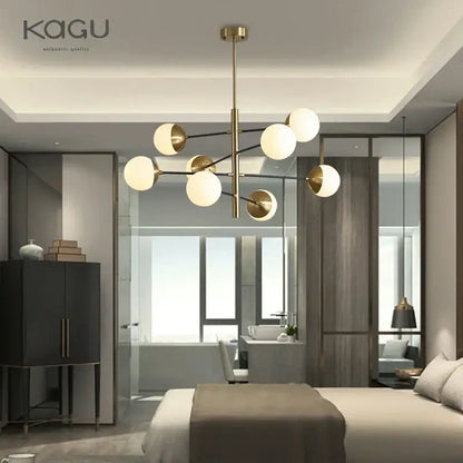 Modern brass-finished chandelier with spherical frosted glass globes for dining room decorbites golden glass magic bean