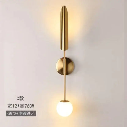 Modern golden inclined tube wall lamp with gold-toned stem and frosted glass bulb for luxury living room decorbites wall lamp