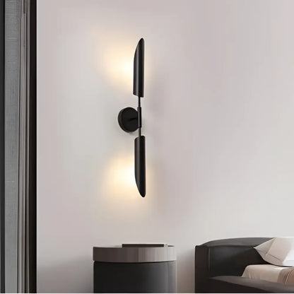 Black minimalist wall lamp with sleek vertical arms and circular base for decorbites golden inclined tube luxury spaces