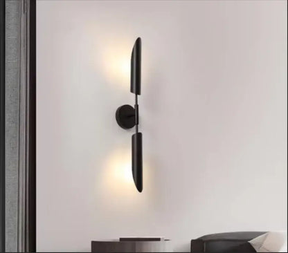 Black matte-finished modern golden inclined tube wall lamp with two vertical cylindrical shades for living room decorbites golden inclined