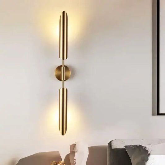 Modern golden inclined tube wall light featuring gold-toned cylindrical arms and a central circular base for living room decorbites golden inclined wall light