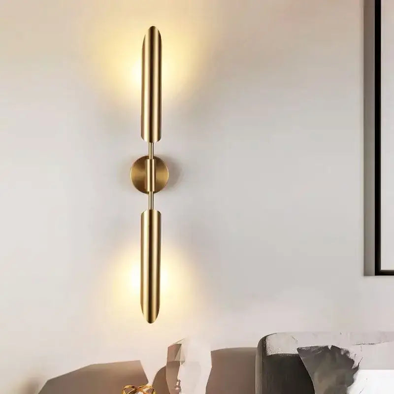 Modern golden inclined tube wall light featuring gold-toned cylindrical arms and a central circular base for living room decorbites golden inclined wall light